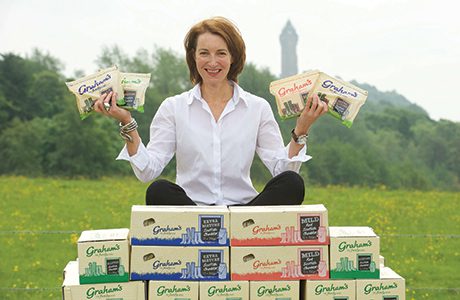 Carol Graham shows off the full range of cheddar cheese available from Graham’s Dairy, including Mild, Mature and Extra Mature.