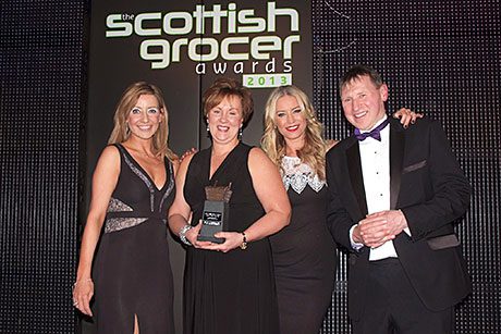 Lee Schofield, Imperial Tobacco’s regional sales manager for Scotland, left, and Denise Van Outen, second right, present the Scottish Grocer Tobacco Retailer of the Year award to Broadway Convenience Store.