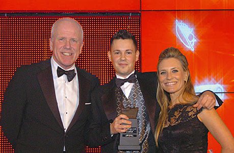 Andrew Helm, key account manager for British American Tobacco, left, and sports TV personality Georgie Thompson, right, present the Scottish Grocer 2014 Employee of the Year Award to Marc McCabe.