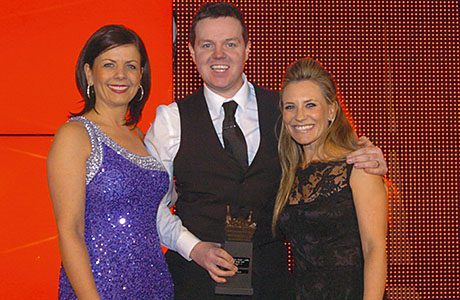 Lucie Cooney, sales director, Scottish Grocer, left, and sports TV personality Georgie Thompson, right, present the Scottish Grocer 2014 Merchandising Award to Spar Thornliebank manager Gerry Haughey.