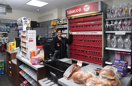 Pictured is Sandeep and Mandeep’s mother, Kuldip Kaur, after whom KK Stores is named. Below, different angles on the main shop floor show the huge difference new flooring, lighting and shelving can make. 