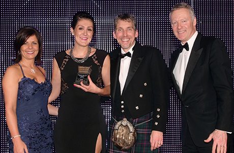 Lucie Cooney, sales director of award sponsor Scottish Grocer magazine, left, and awards event former host Rory Bremner, right, present the Scottish Grocer 2015 Symbol Store of the Year (single store) Award to Nisa Local Pinkie Farm.