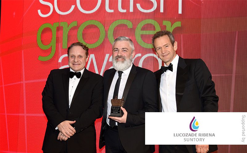 Matthew Gouldsmith, Lucozade Riberna Suntory, and Alexander Armstrong present the Innovation in Impulse Award to Scott Graham, McLeish, Inverurie.