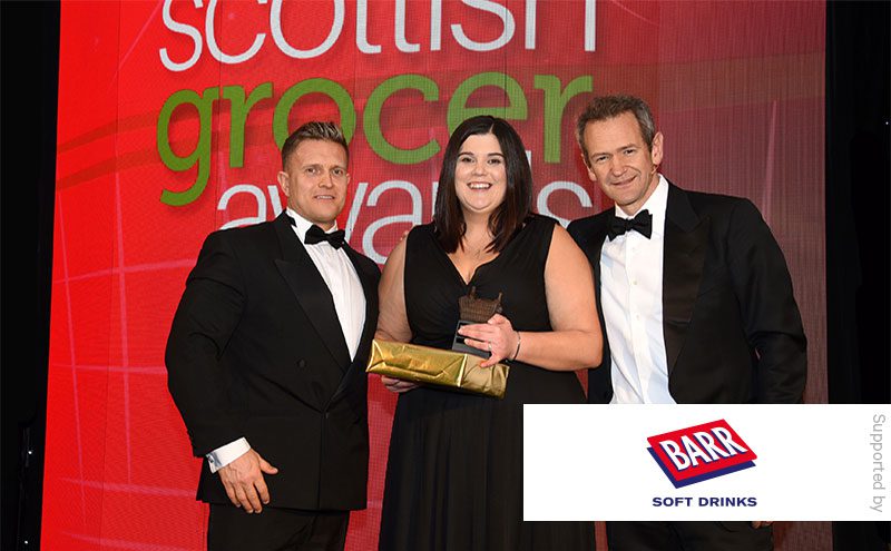 Mark Taylor, sales development manager at Barr Soft Drinks, and Alexander Armstrong present the Best New Store award to Samantha Stalker, Spar Halbeath.